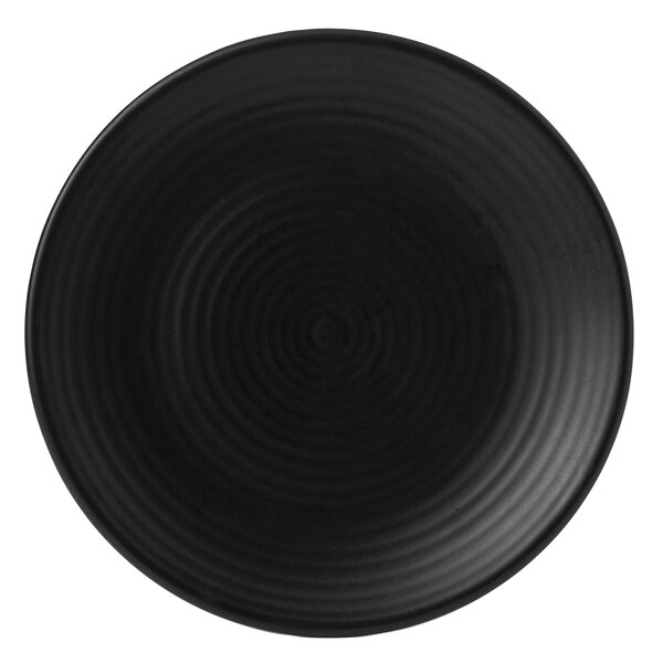 A black Dudson Evo stoneware plate with a spiral design in the center.