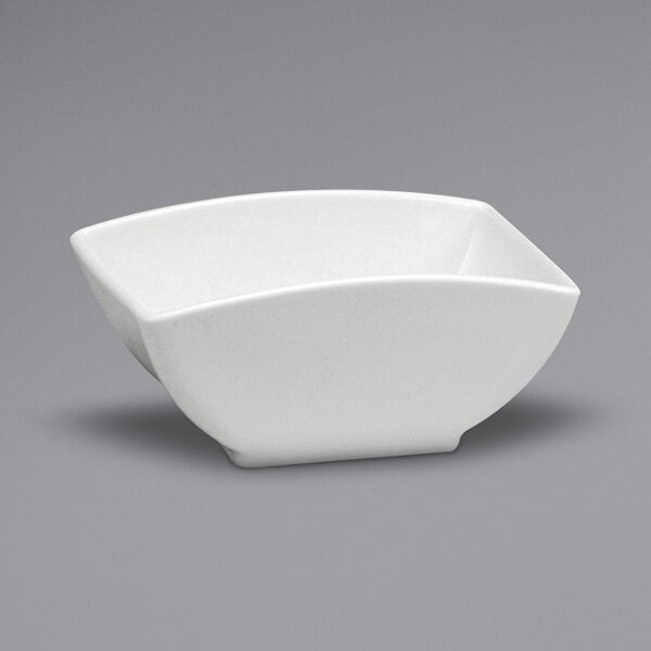 A warm white porcelain square sugar caddy with a small handle.