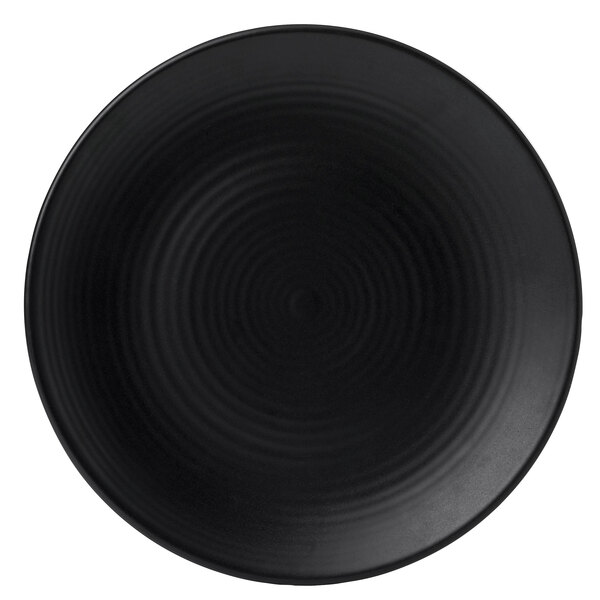 A black Dudson Evo stoneware plate with spiral lines on it.
