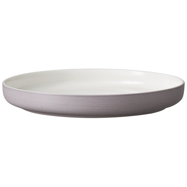 A Luzerne white porcelain deep plate with a gray speckled rim.