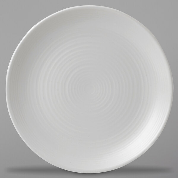 A close up of a Dudson Matte Pearl stoneware plate with spiral lines on it.