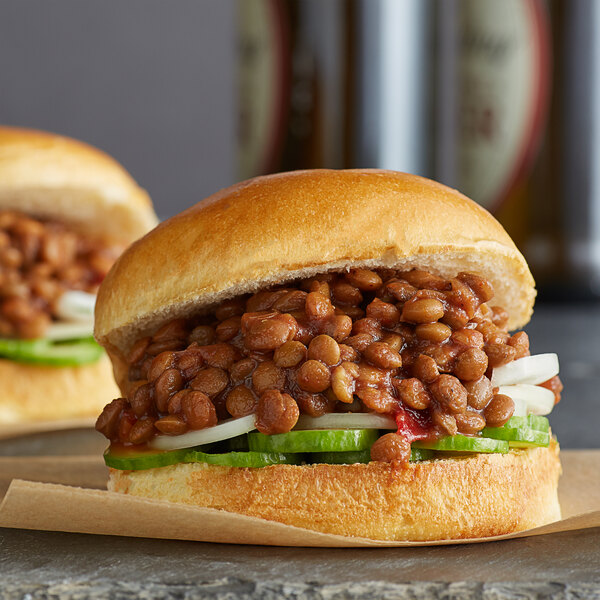 A close-up of a sandwich with lentils on it.