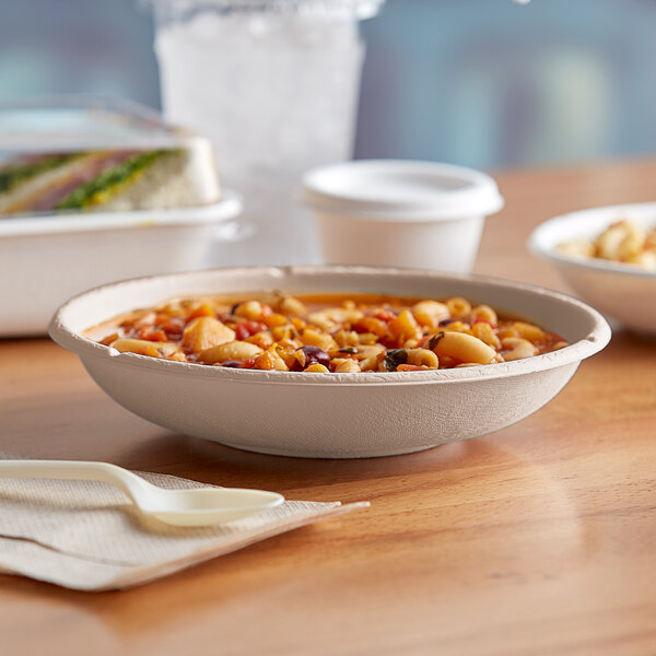 A bowl of food in a natural compostable bowl on a table.