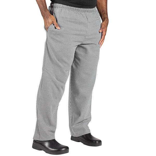 A person wearing Uncommon Chef houndstooth chef pants.
