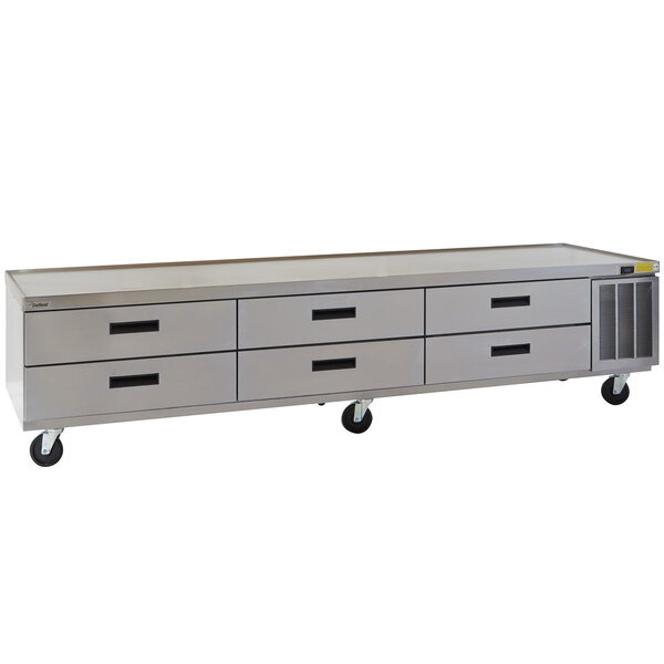 A stainless steel Delfield chef base with drawers on wheels.
