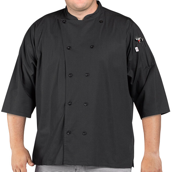 A man wearing a black Uncommon Chef 3/4 sleeve chef coat with side vents.
