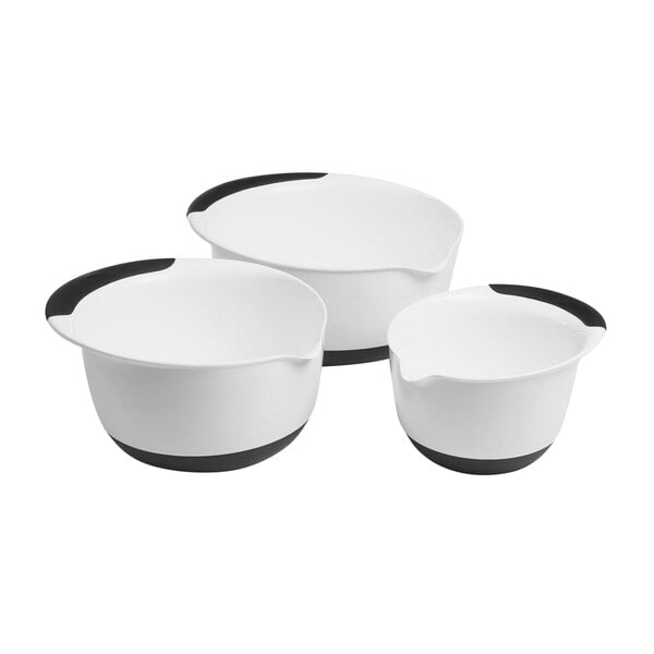 A group of three white OXO mixing bowls with black non-slip bases.