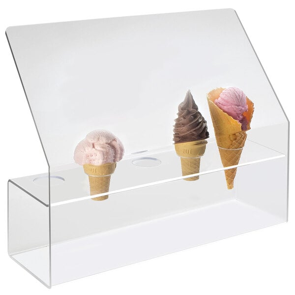 A clear plastic case with five ice cream cones inside and a sneeze guard.