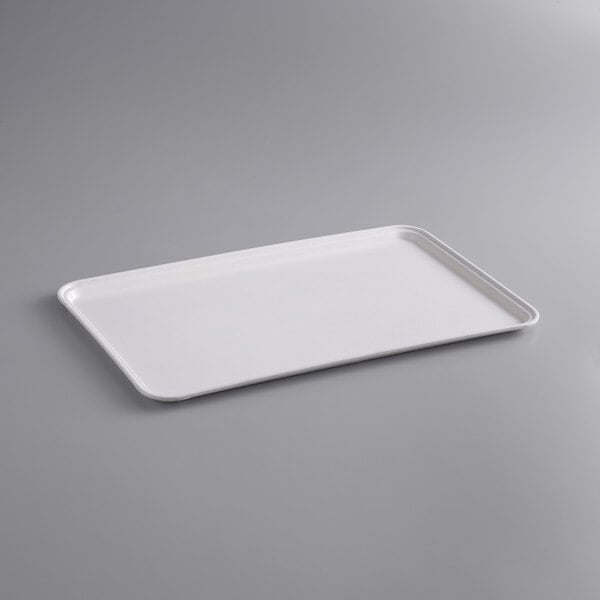 A white rectangular MFG Tray on a gray surface.