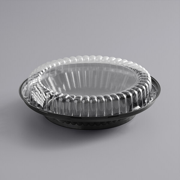 A Baker's Mark black plastic pie container with a clear lid.