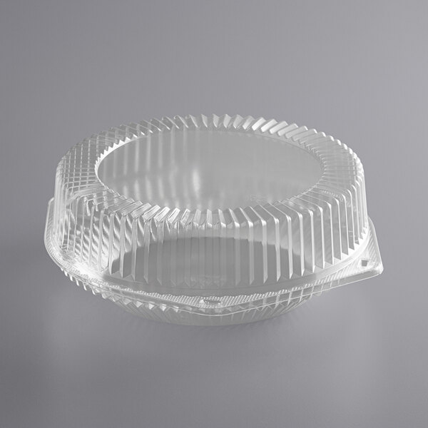 A clear plastic Choice pie container with a high dome lid and wavy edge.