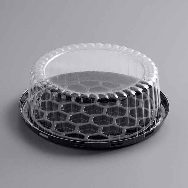 A black plastic Choice cake container with a clear lid.