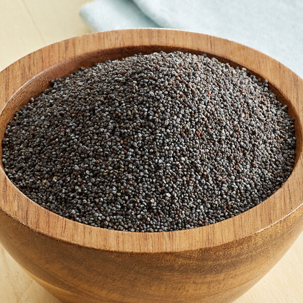 A bowl of Regal poppy seeds on a table.