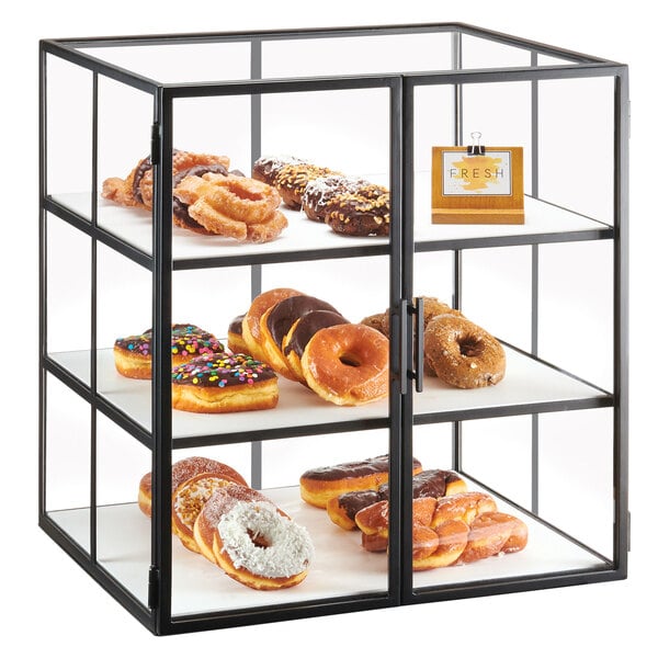 A Cal-Mil Monterey bakery display case with donuts and other pastries.