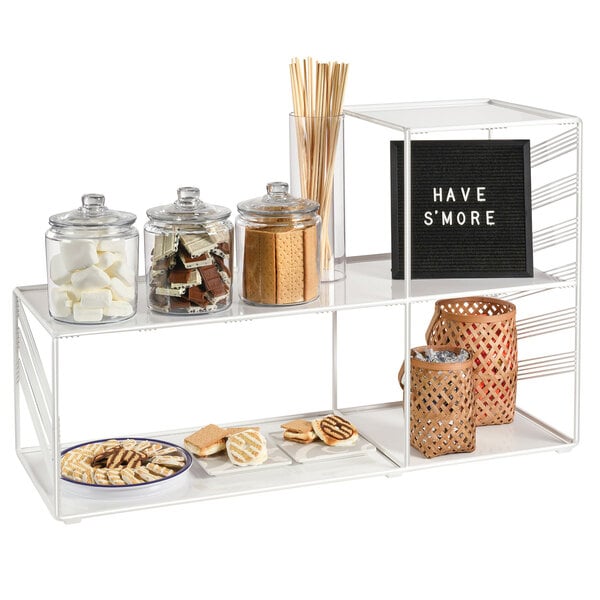 A white Cal-Mil wire library display shelf with snacks on it.