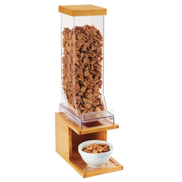 A Cal-Mil Madera cereal dispenser with a bowl of cereal.