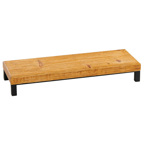 A wooden rectangular object with black legs.