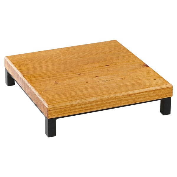 A wood square riser with black legs.