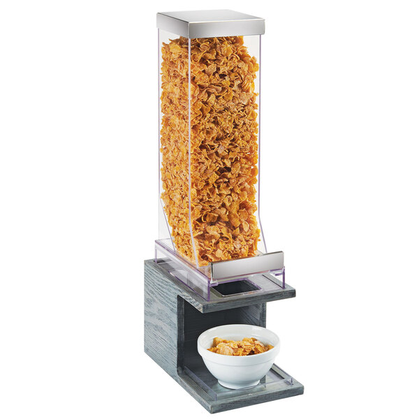 A Cal-Mil Ashwood cereal dispenser with a bowl of cereal.