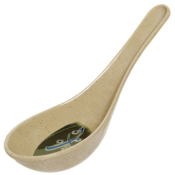 A beige traditional soup spoon with a design on it.