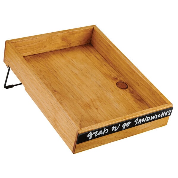 A wooden box merchandiser with a chalkboard label on a table.