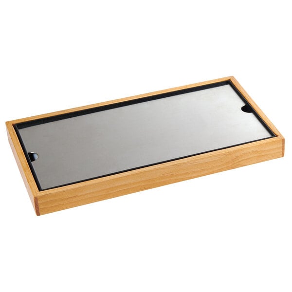 A rectangular wooden frame with a black border holding a silver plate.