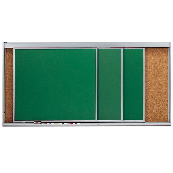 A green rectangular cork board with white trim and 3 sliding chalk boards.