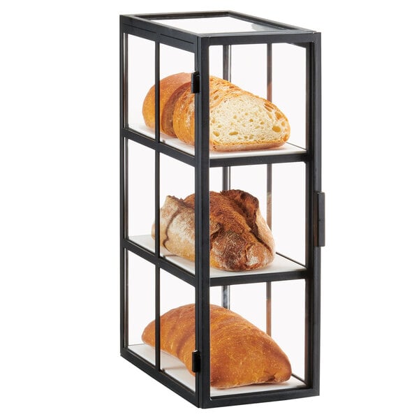 A black metal Cal-Mil bakery display case with shelves of different types of bread.