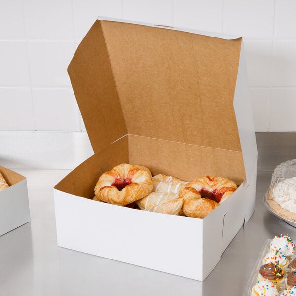A white 12" x 12" bakery box filled with cupcakes and pastries.
