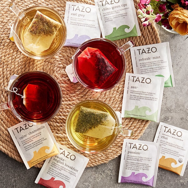 A variety of Tazo tea bags on a mat.