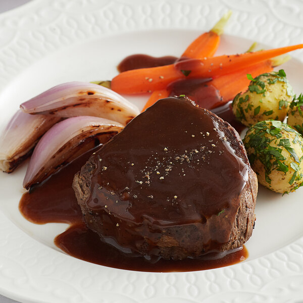 A plate of food with Knorr Ultimate Demi Glace sauce, meat, and vegetables.