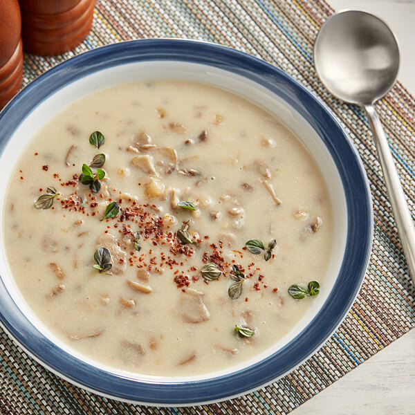 A bowl of Knorr Cream of Mushroom soup with spices and herbs.