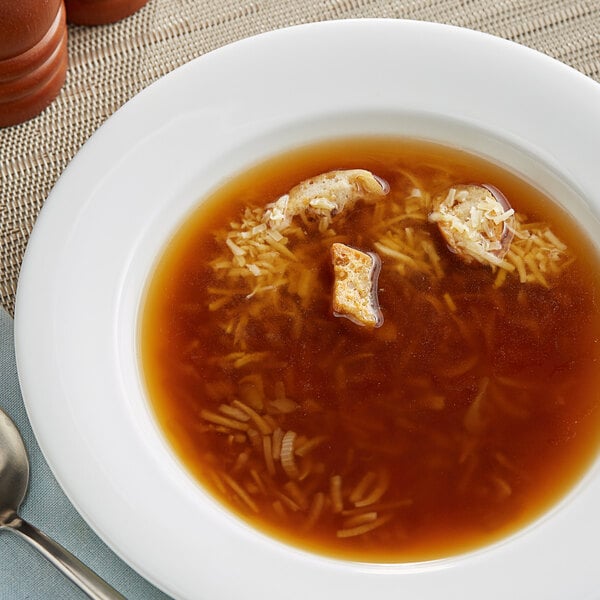 A bowl of onion soup with croutons.