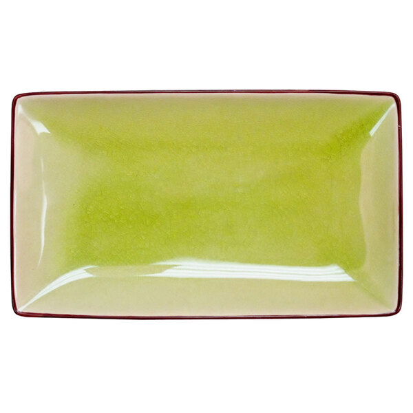 A black rectangular stoneware plate with a green rim.