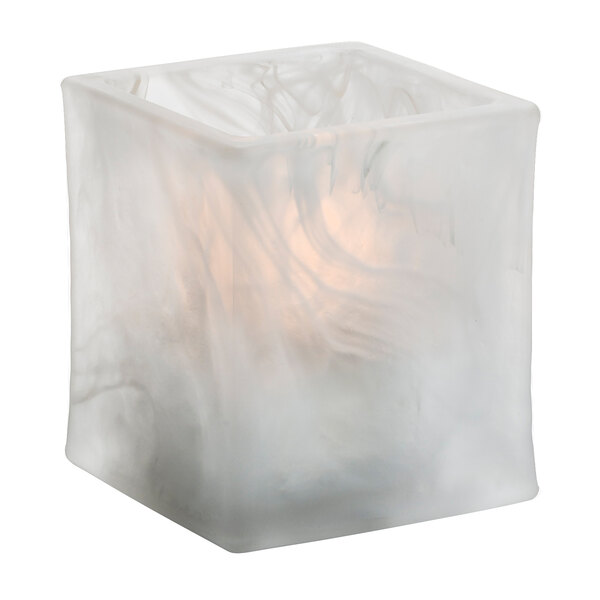 A white square glass Hollowick tealight holder with a lit candle inside.