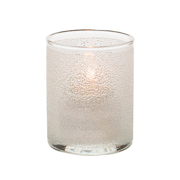 A Hollowick clear glass cylinder tealight holder with a lit candle.