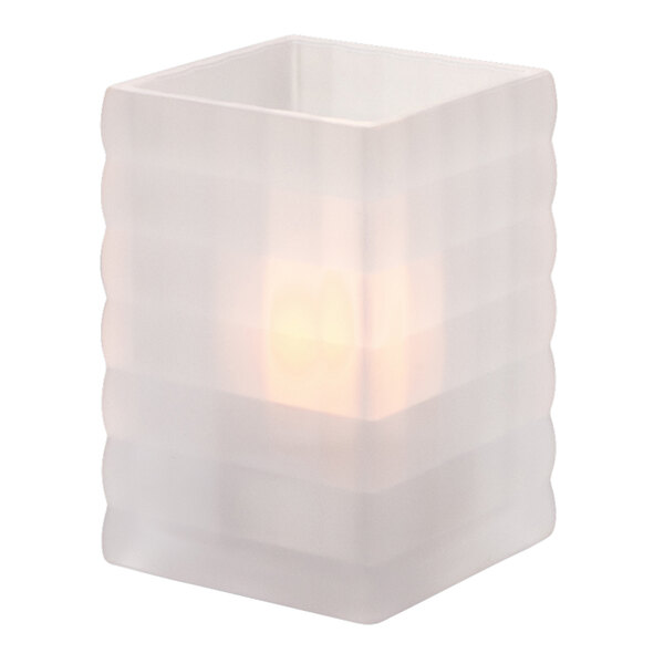 A white glass crystal candle holder with a light inside.