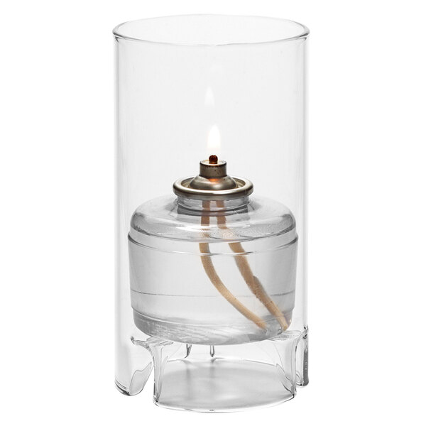 A Hollowick clear glass cylinder candle holder with a flame inside.