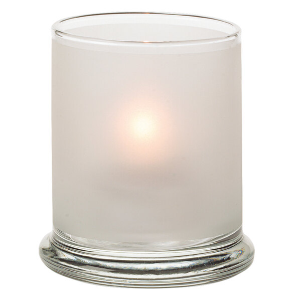 A Hollowick satin crystal glass candle holder with a lit candle inside.