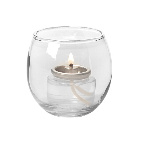 A small clear glass Bubble tealight lamp with a lit tealight inside.