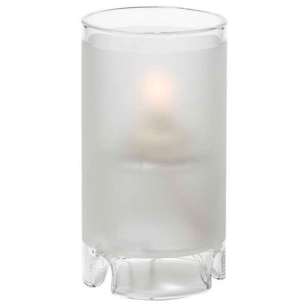 A clear glass Hollowick Mini Satin Crystal cylinder candle holder with a lit candle inside.