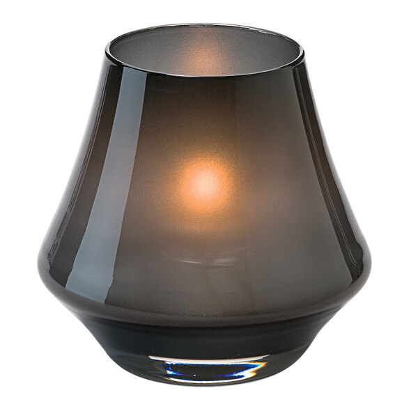 A black glass Hollowick Chime votive candle holder with a light inside.