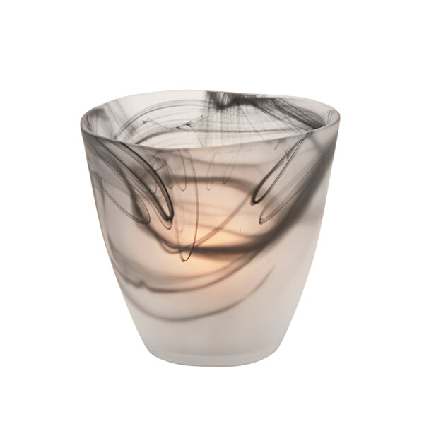 A Hollowick Wysp Satin Black Glass Votive with a black and white swirled candle inside.