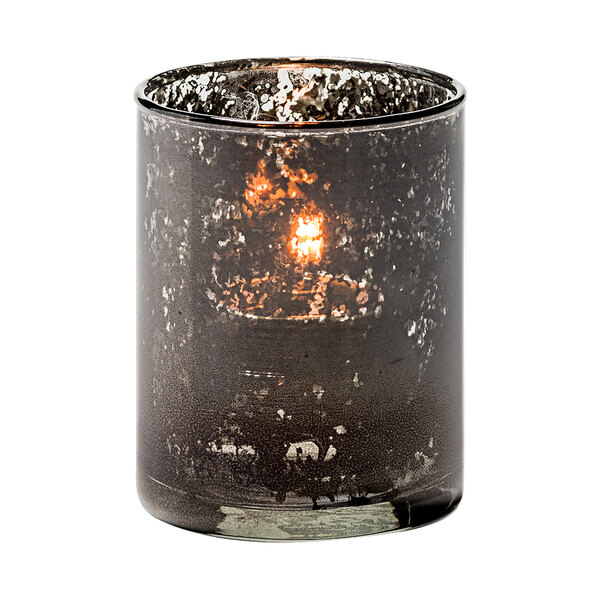 An Antique Black Glass Cylinder Tealight with a lit candle inside.