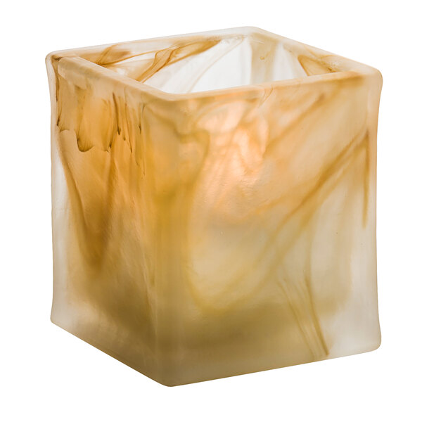 A square glass container with a brown and white marble design holding a Hollowick Glacier Caramel Wysp tealight.