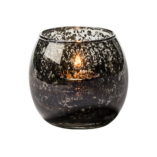 A lit white candle in a Small Antique Black Glass Bubble Tealight Lamp.