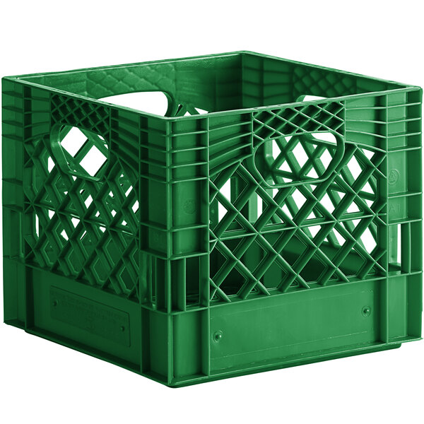 A green plastic milk crate with holes and handles.