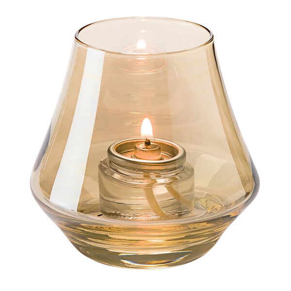 A Hollowick gold lustre glass votive with a lit candle inside.