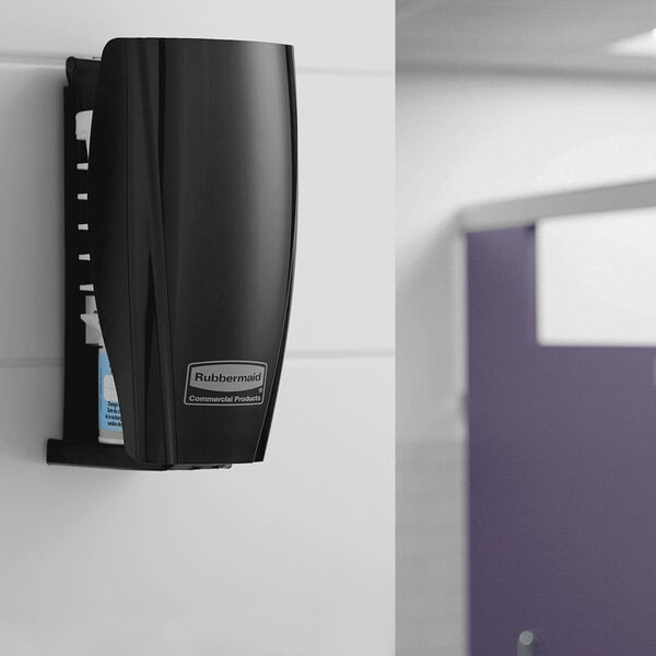 A black Rubbermaid TCell wall-mounted air freshener system.