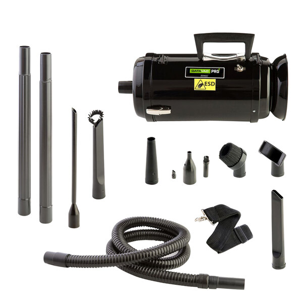 A black MetroVac handheld toner vacuum cleaner with many attachments.